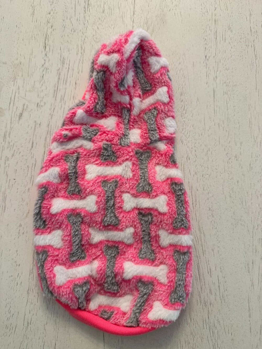 Dog warm sweater, hot pink with grey and white dog bones print. Size Small
